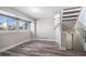 Finished basement with wood-look flooring, bright windows, and stairs to the upper level at 3738 Rosewalk Ct, Highlands Ranch, CO 80129