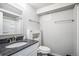 Bright bathroom featuring a granite countertop, white cabinets and a shower with built in shelving at 3738 Rosewalk Ct, Highlands Ranch, CO 80129