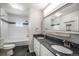 Bathroom with double sink vanity, granite countertop, modern fixtures, and a tiled shower at 3738 Rosewalk Ct, Highlands Ranch, CO 80129