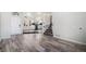 Bright entryway with wood-look floors and view into kitchen at 3738 Rosewalk Ct, Highlands Ranch, CO 80129