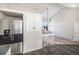 Kitchen view showcasing stainless steel refrigerator and staircase access to the next level at 3738 Rosewalk Ct, Highlands Ranch, CO 80129