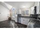 Modern kitchen with stainless steel appliances, granite countertops, and ample natural light from shuttered windows at 3738 Rosewalk Ct, Highlands Ranch, CO 80129