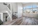 Bright and spacious living room with a view and wood-look flooring at 3738 Rosewalk Ct, Highlands Ranch, CO 80129