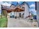 Backyard with patio, upper deck, swing and white siding on home at 13080 County Road 19, Platteville, CO 80651