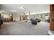 This spacious basement is multi purpose with two living areas, a TV, and a ping pong table at 13080 County Road 19, Platteville, CO 80651