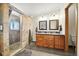 Bathroom with walk-in shower, dual sinks, and granite countertops at 13080 County Road 19, Platteville, CO 80651