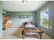 Bright bedroom with a bed, desk, and a large window overlooking the scenic outdoors, blending comfort and tranquility at 13080 County Road 19, Platteville, CO 80651