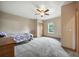 Cozy bedroom with plush carpet, ceiling fan, closet, and a sunlit window, creating a warm and inviting space at 13080 County Road 19, Platteville, CO 80651