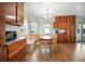 Eat-in kitchen with wooden cabinetry, floors, and breakfast nook with large windows and plenty of natural light at 13080 County Road 19, Platteville, CO 80651