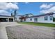 Exterior with garage, driveway and lawn on bright day at 13080 County Road 19, Platteville, CO 80651
