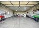 Well-lit garage with smooth concrete floor and overhead lighting for a clean workspace at 13080 County Road 19, Platteville, CO 80651