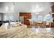 Well-lit kitchen with stainless steel appliances, granite countertops, and a cozy breakfast nook with many windows at 13080 County Road 19, Platteville, CO 80651