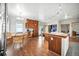 This kitchen features wood floors and includes dining and kitchen island seating at 13080 County Road 19, Platteville, CO 80651