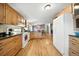 Open floor plan kitchen with hardwood floors and white appliances at 13080 County Road 19, Platteville, CO 80651
