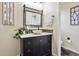 Bathroom with dark vanity, vessel sink, and modern fixtures at 3379 Cranston Cir, Littleton, CO 80126