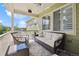 Relaxing covered deck with cozy furniture and neighborhood views at 3379 Cranston Cir, Littleton, CO 80126