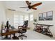 A home office featuring a ceiling fan, computer, and bookshelves at 3379 Cranston Cir, Littleton, CO 80126