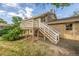 Backyard featuring a deck, stairs, and brick accents on the home's exterior at 12883 E Nevada Cir, Aurora, CO 80012