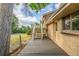 Backyard view with brick house, wooden deck, and concrete patio at 12883 E Nevada Cir, Aurora, CO 80012