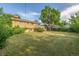 Expansive backyard with large trees and a view of the home's deck at 12883 E Nevada Cir, Aurora, CO 80012