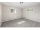 Light-filled bedroom featuring gray carpet, neutral paint, and multiple windows at 12883 E Nevada Cir, Aurora, CO 80012