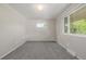 A bright bedroom with neutral walls, carpet, and two windows at 12883 E Nevada Cir, Aurora, CO 80012