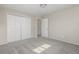 Bedroom featuring neutral paint, gray carpet, closet and an entrance to the hall at 12883 E Nevada Cir, Aurora, CO 80012
