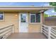 Outdoor deck with white railings and a house painted pale yellow at 12883 E Nevada Cir, Aurora, CO 80012