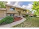 Suburban home featuring neutral siding, a manicured lawn, and inviting curb appeal at 12883 E Nevada Cir, Aurora, CO 80012