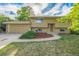 Charming home featuring a two-car garage, well-maintained lawn, and an inviting entrance at 12883 E Nevada Cir, Aurora, CO 80012