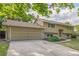 Home with a two-car garage, neutral siding, and a neatly landscaped front yard at 12883 E Nevada Cir, Aurora, CO 80012