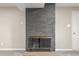 A modern gray brick fireplace with metal screen at 12883 E Nevada Cir, Aurora, CO 80012