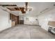 Unfinished garage with concrete floors, white walls and exposed ceiling beams at 12883 E Nevada Cir, Aurora, CO 80012