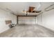 An empty two-car garage with concrete flooring at 12883 E Nevada Cir, Aurora, CO 80012