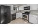 Updated kitchen featuring stainless steel appliances, white cabinets and neutral countertop at 12883 E Nevada Cir, Aurora, CO 80012