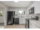 Updated kitchen with white cabinets, quartz counters and stainless steel appliances at 12883 E Nevada Cir, Aurora, CO 80012