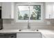 Bright kitchen showcasing quartz counters, stainless sink, and a window view at 12883 E Nevada Cir, Aurora, CO 80012
