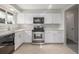 Updated kitchen featuring quartz counters, stainless appliances and white cabinets at 12883 E Nevada Cir, Aurora, CO 80012