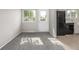 Bright living room with gray carpet, neutral paint, and a door to the outside at 12883 E Nevada Cir, Aurora, CO 80012