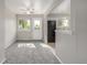 Bright living room featuring neutral paint, gray carpet, and access to the kitchen at 12883 E Nevada Cir, Aurora, CO 80012