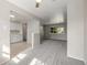 Open-concept living area with gray carpet adjacent to kitchen and neutral paint at 12883 E Nevada Cir, Aurora, CO 80012