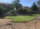 Lush backyard with a sprinkler system and concrete patio, perfect for enjoying the outdoors at 270 Terra Vista St, Brighton, CO 80601