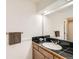 Well-lit bathroom featuring tile countertop, white sink, and stylish black tiled backsplash at 270 Terra Vista St, Brighton, CO 80601