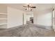 Spacious bedroom with neutral carpet, ceiling fan, built in shelving and multiple doors at 270 Terra Vista St, Brighton, CO 80601