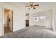 Bright bedroom with modern ceiling fan, neutral carpet, and a large window at 270 Terra Vista St, Brighton, CO 80601