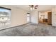 Bright bedroom featuring neutral carpet, large windows, ceiling fan and attached bathroom at 270 Terra Vista St, Brighton, CO 80601