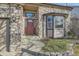 Inviting front entrance showcasing a stone exterior, a decorative door, and well-maintained landscaping at 270 Terra Vista St, Brighton, CO 80601