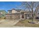 Charming two-story home featuring a stone facade and a well-manicured lawn on a sunny day at 270 Terra Vista St, Brighton, CO 80601