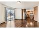 Bright living room with sliding door access to backyard and hardwood floors leading into kitchen at 270 Terra Vista St, Brighton, CO 80601