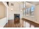 Spacious living room with high ceilings, large windows, fireplace, and hardwood flooring at 270 Terra Vista St, Brighton, CO 80601